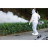 Operator in protective gear fogging street park,